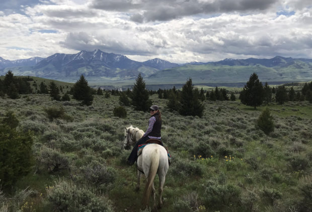 The author and her horse, Ivan, explore the ranch’s rugged landscape.